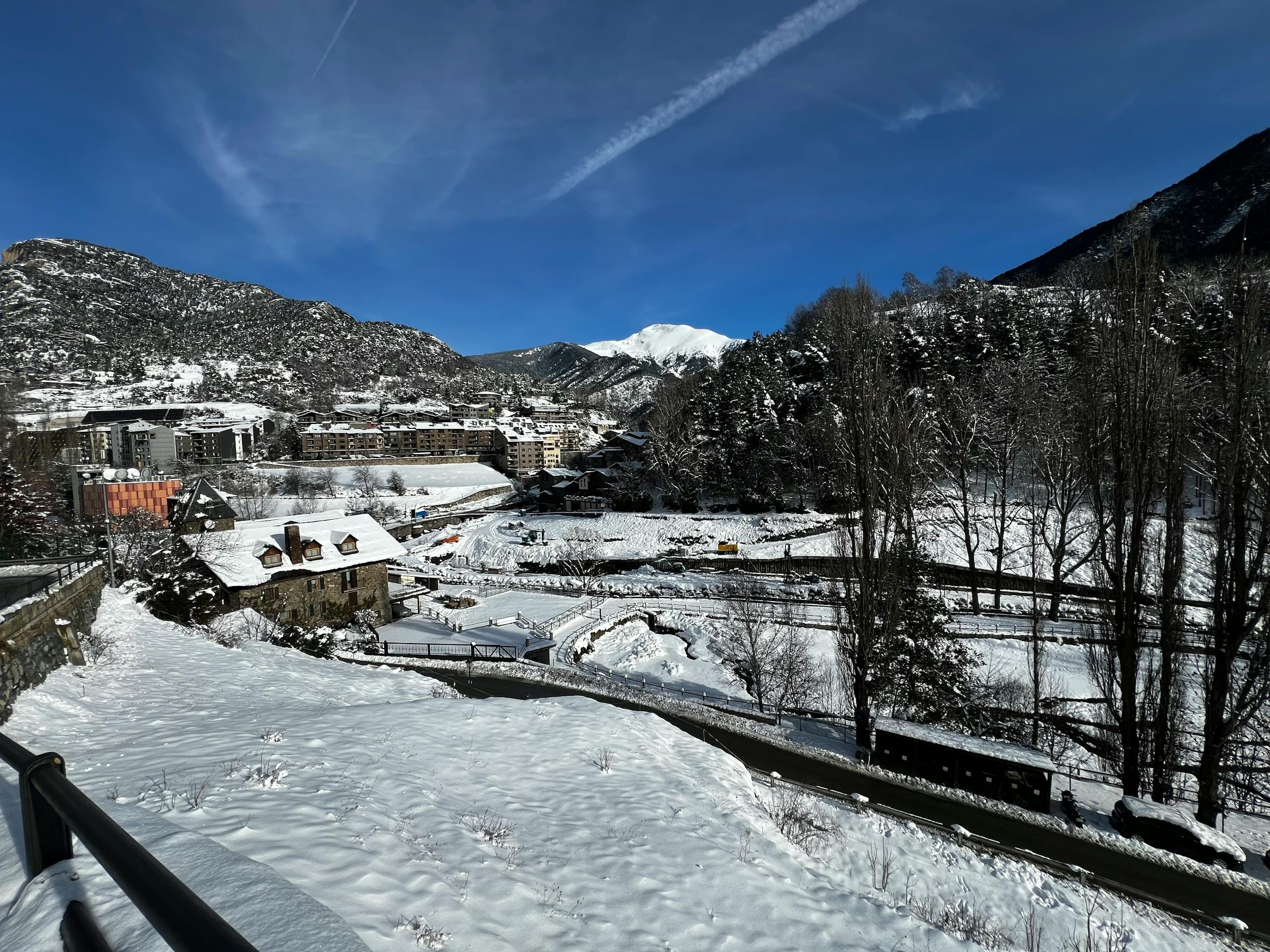 Stafford Affiliates Travel - Scenic winter view of La Massana in Andorra with snow-covered mountains and buildings.