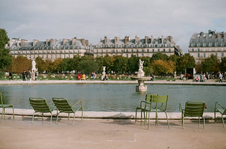 Stafford Affiliates Travel - Charming scene of the Tuileries Garden with iconic Parisian architecture and a peaceful fountain view.