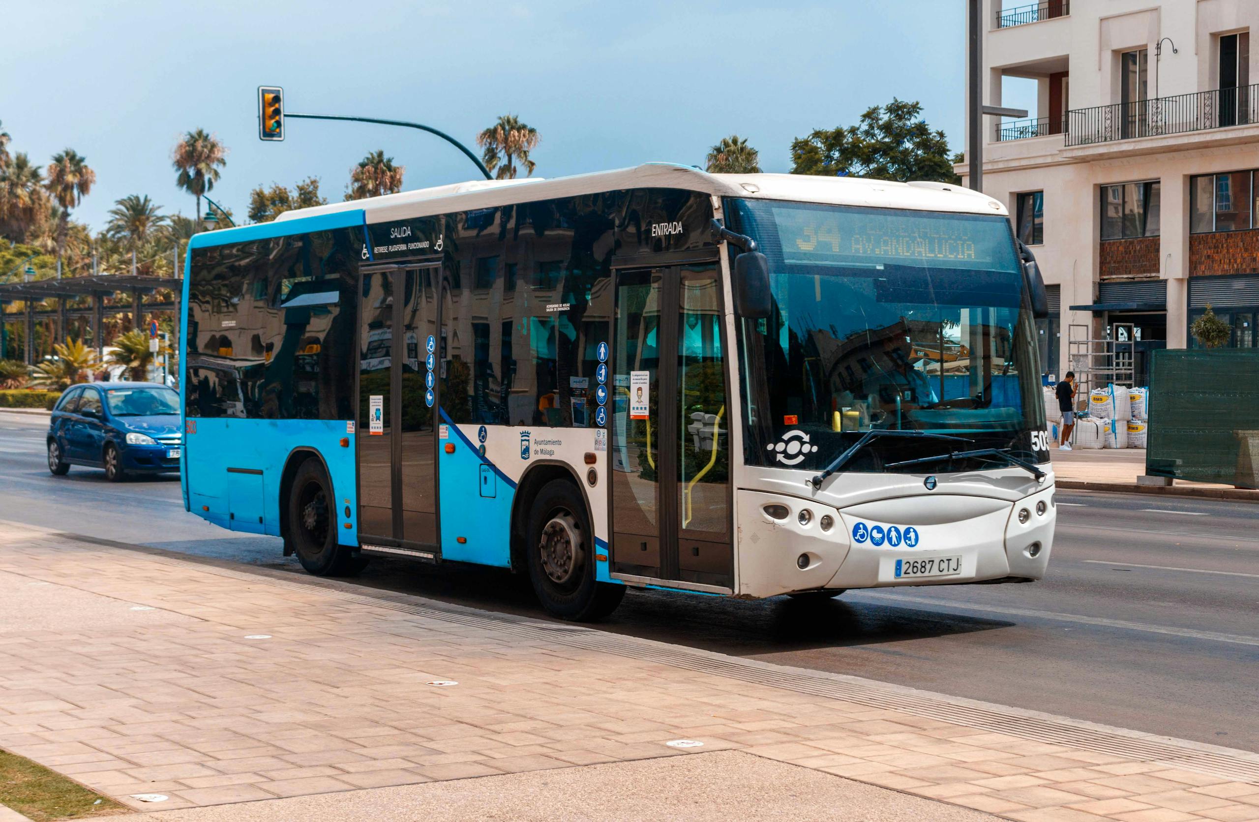 Stafford Affiliates Travel -Public bus on a sunny day in Málaga, showcasing urban transportation.
