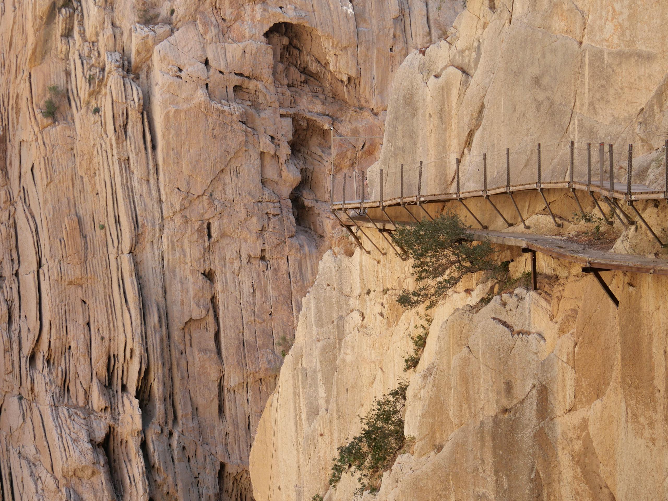 Stafford Affiliates Travel - Thrilling view of Caminito del Rey walkway along steep rock walls in Spain.