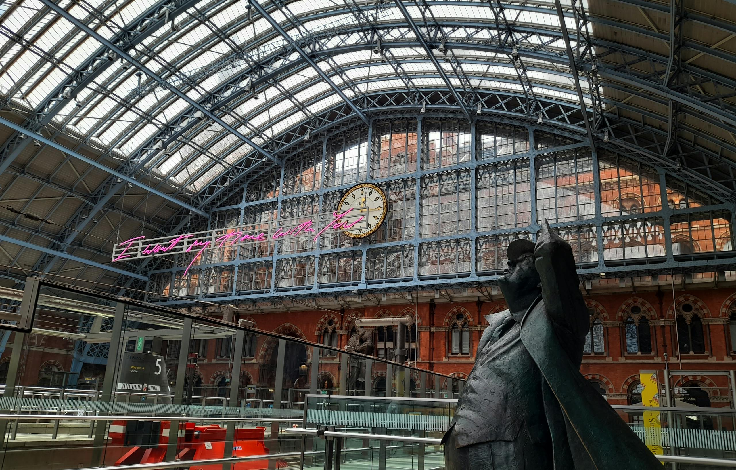 Interior view of St Pancras International Station with clock and statue. Stafford Affiliates Travel