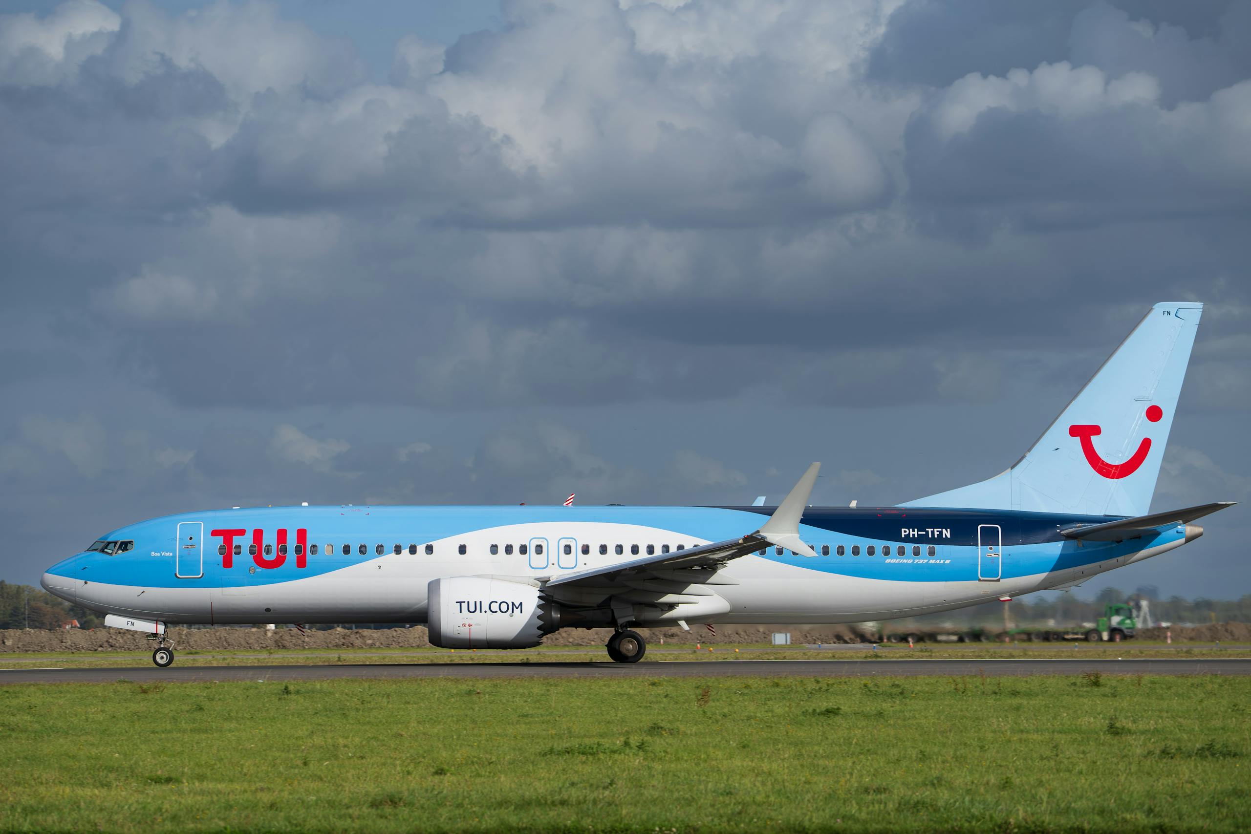 TUI Airlines jet taxiing on runway against cloudy sky, captured in daylight - Stafford Affiliates Travel