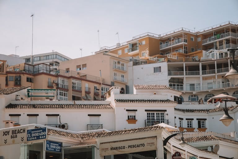 A picturesque scene of Spanish architecture in Málaga, highlighting classic balconies and blue skies - Stafford Affiliates Travel