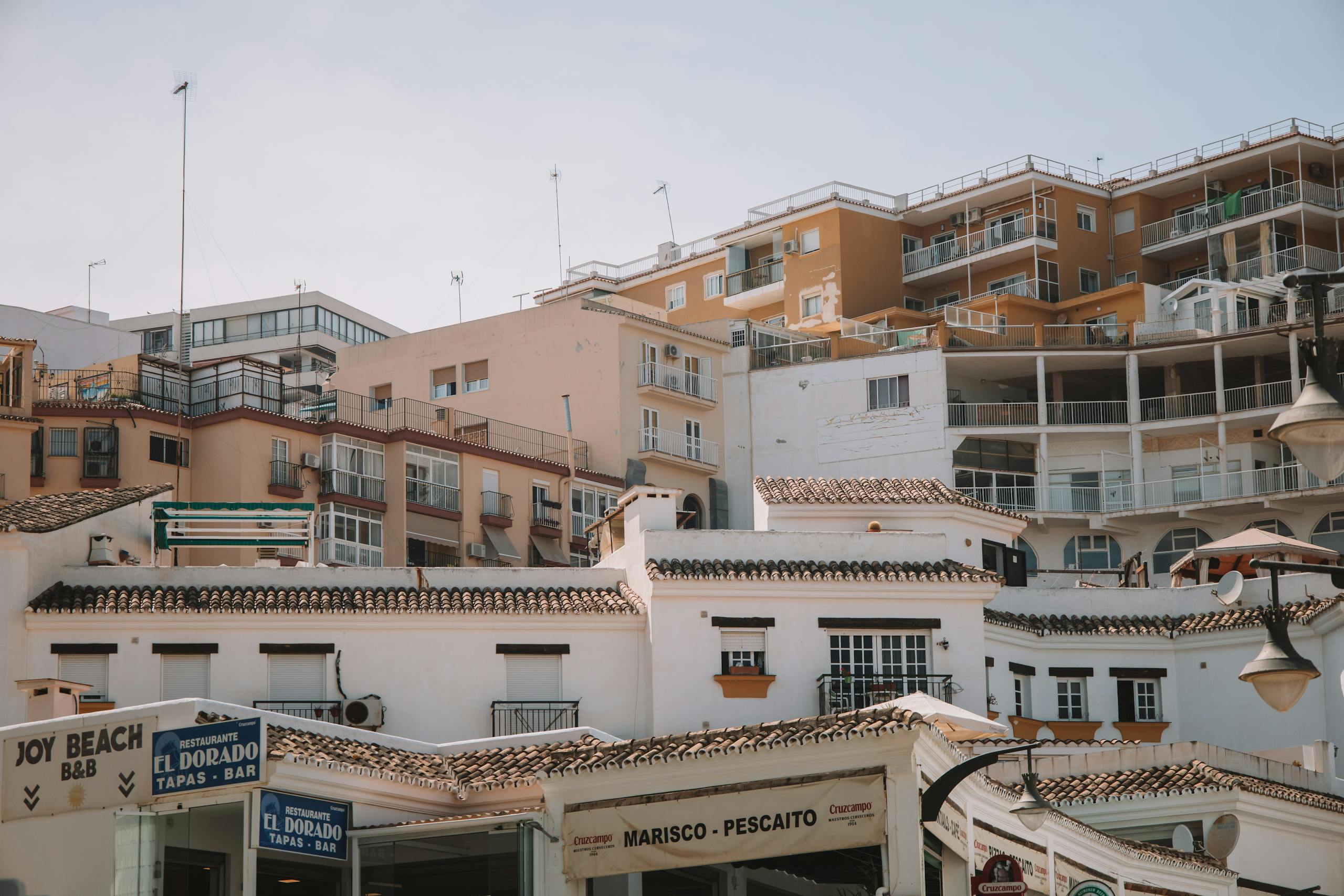 A picturesque scene of Spanish architecture in Málaga, highlighting classic balconies and blue skies - Stafford Affiliates Travel