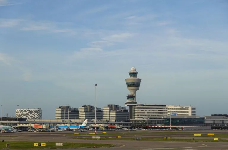 Panoramic view of Amsterdam's Schiphol Airport with control tower on a clear day Stafford Affiliates Travel