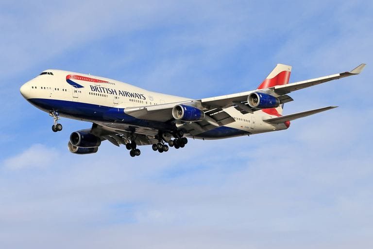 A British Airways Boeing 747 aircraft flying against a blue sky Stafford Affiliates Travel