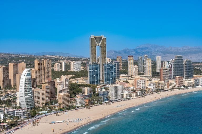Aerial view of Benidorm's beachfront with iconic Intempo building.- Stafford Affiliates Travel